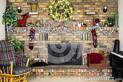 Cozy room with brick fireplace decorated for Christmas, rocking Stock Photo