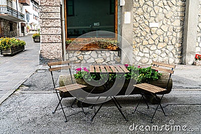 Cozy street chairs and table in heart of Cortina d`Ampezzo, Italy Stock Photo