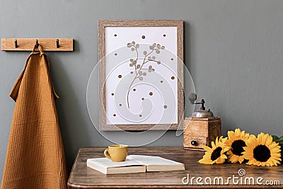 Cozy and stylish composition of creative dining room with mock up poter frame, wooden console, sunflowers and personal accessory. Stock Photo