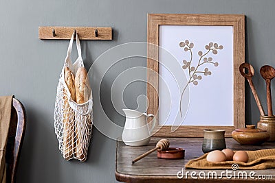 Cozy and stylish composition of creative dining room with mock up poter frame, wooden console, sunflowers and accessories. Stock Photo