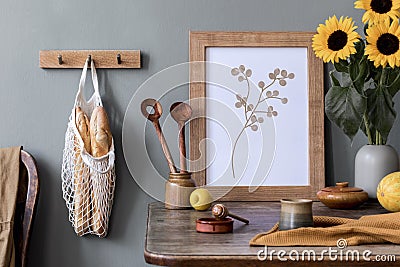 Cozy and stylish composition of creative dining room with mock up poter frame, wooden console, sunflower and personal accessories. Stock Photo