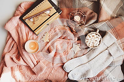 cozy winter or Christmas table with seasonal fashion clothes, hot cocoa and candles Stock Photo