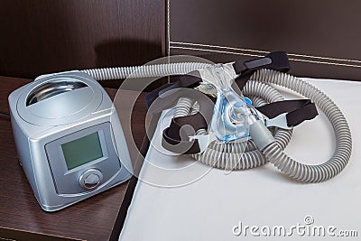 CPAP machine with air hose and head gear mask Stock Photo
