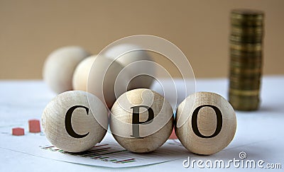 CPO - abbreviation on wooden balls on a background of coins and graphics Stock Photo