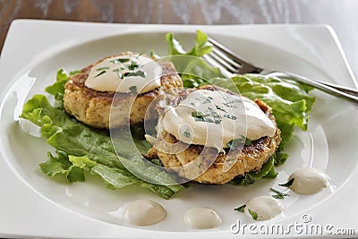 Crab cakes with creamy mustard sauce Stock Photo