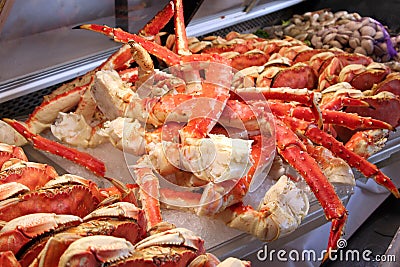 Crab and clams on ice at a fish market Stock Photo