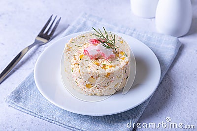 Crab salad with corn and eggs on a white plate. Serving in portions. Traditional Russian salad. Stock Photo