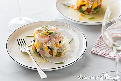 Crab and shrimp stack salad made with mango, cucumber and avocado. Stock Photo