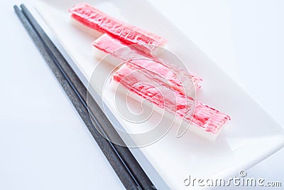 Crab sticks group with chopsticks on white background Stock Photo