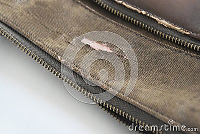 Crack of brown leatherette bag Damage due to lifetime Stock Photo