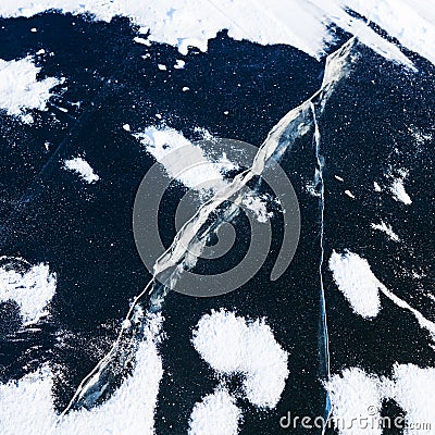 Crack in ice on surface frozen river in winter Stock Photo