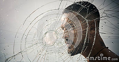 Crack. macho man behind crushed glass. anger. destruction. crush test. theft. emotional discharge. bullet hole in glass Stock Photo