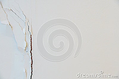 A crack in the white wall of the house after the earthquake. Poor repair, cracked plaster, poorly treated walls during repairs. Stock Photo