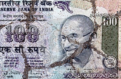 On the cracked asphalt there is an image of a banknote of India Editorial Stock Photo