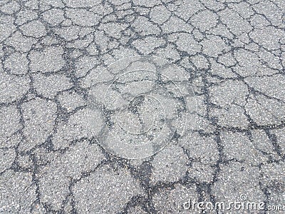 Cracked or damaged black asphalt or pavement Stock Photo