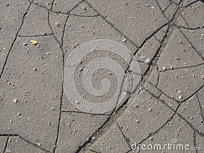 Cracked gray asphalt texture with small stones Stock Photo