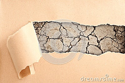 Cracked ground behind torn paper Stock Photo