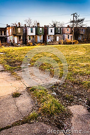 Cracked sidewalk and abandoned row houses in Baltimore, Maryland Stock Photo