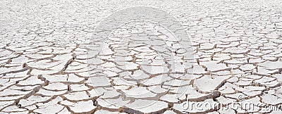 Cracked white clay, dried lakebed surface texture. Panorama with diminishing perspective Stock Photo