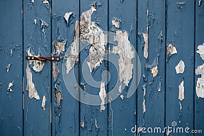 Crackle oil paint texture of old wooden door background. Multi layers of peeling paint with cracks. Stock Photo