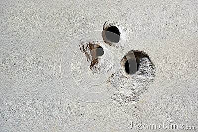 Cracks holes on the cement wall Caused by drilling To put the plumbing tube in the house Stock Photo