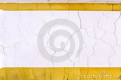 Cracks on the wall. White wall with a yellow contour. Rolling off plaster. Old vintage wall. White and yellow lines Stock Photo