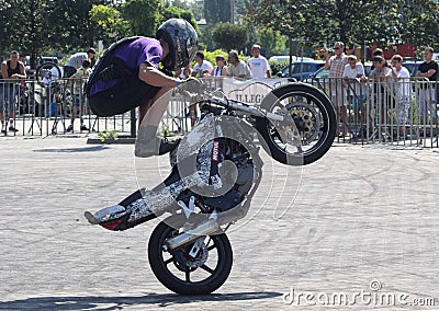 Young motorbiker performing stunts on his tuned bike Editorial Stock Photo