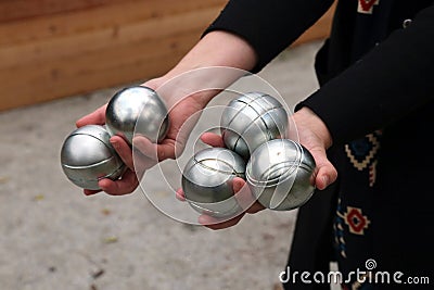 Hands hold petanque steel balls. Editorial Stock Photo