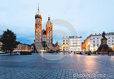 Cracow, Poland old town with St. Mary's Basilica and Adam Mickiewicz monument at the evening Stock Photo