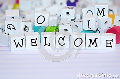 Craft and alphabet blocks on looseleaf paper Welcome Stock Photo