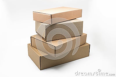 Stacked boxes of brown cardboard on a white background, recyclable material Stock Photo