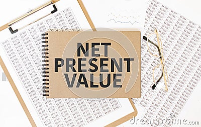 Craft colour notepad with text net present value. Notepad with eyeglasses and text documents. Business concept Stock Photo