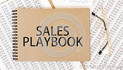 Craft colour notepad with text SALES PLAYBOOK. Notepad with eyeglasses and text documents. Business concept Stock Photo