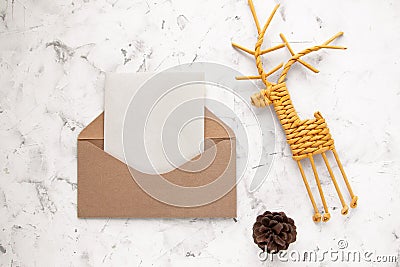 Craft kraft paper envelope, fir cone and vine deer on light background, flat lay, top view Stock Photo