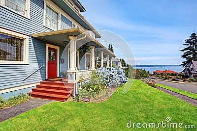 Craftsman American house in blue tones with wooden walkout porch Stock Photo