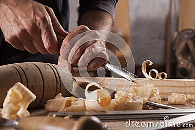 Craftsman carve with a gouge Stock Photo