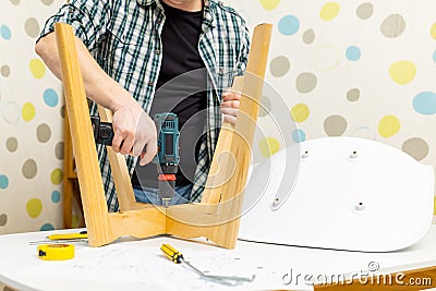 Craftsman collecting with tools, assembling furniture with screwdriver Stock Photo
