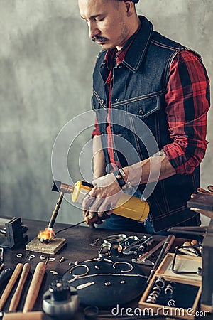 Craftsman concentrated on working with flame Stock Photo