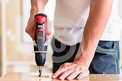 Craftsman or DIY man working with power drill Stock Photo