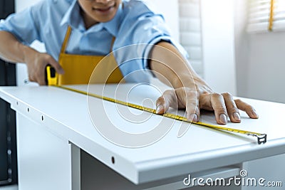 Craftsman doing renovation work at home improvement with measure wooden floor and interior design concept Stock Photo