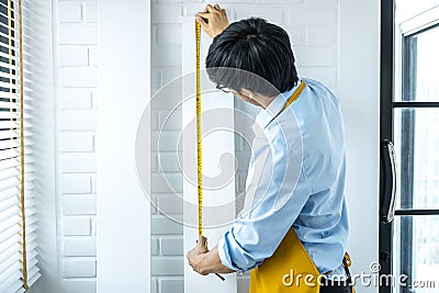 Craftsman doing renovation work at home improvement with measure wooden floor and interior design concept Stock Photo