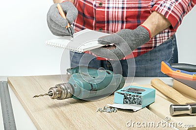 Craftsman drawing and planning at workplace. Stock Photo