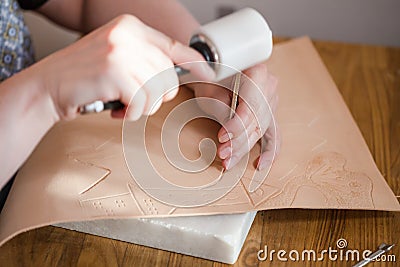 Craftsman emboss picture on leather Stock Photo