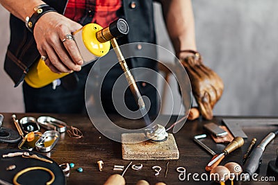 Craftsman heating the metal, close up photo Stock Photo