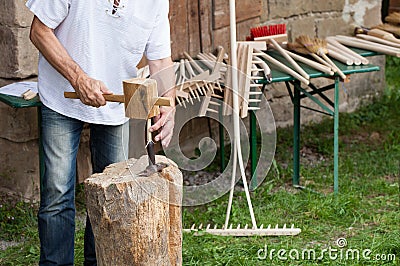 Craftsman produces wooden rake tooth Stock Photo