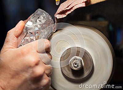 Craftsman during sanding of a crystal ashtrays Stock Photo