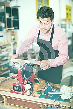 Craftsman working on woodworking machine Stock Photo