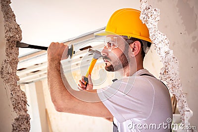 Crafty handyman wearing yellow helmet Stock Photo