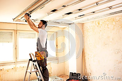 Crafty worker arranging ceiling construction Stock Photo