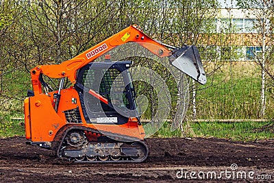 Cramo mini loader leveling the ground in the park Editorial Stock Photo